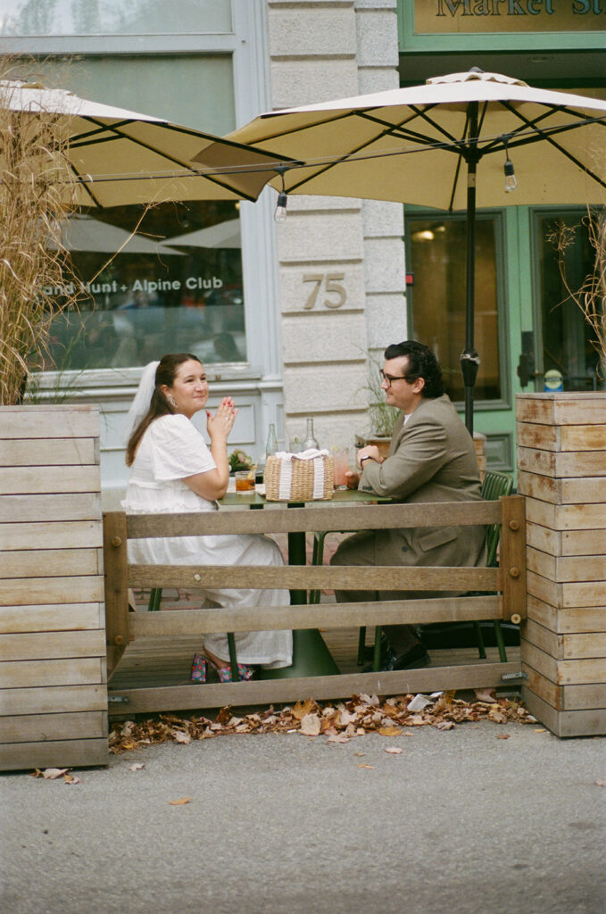 A couple having drinks in the Old Port after their Portland City Hall Ceremony. Portland, Maine Elopement inspiration. 