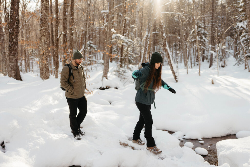 Crossing a stream on a winter hike in new hampshire 