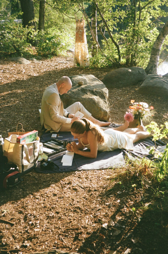 Chocorua Lake elopement picnic. Writing vows before saying I do in the lake 