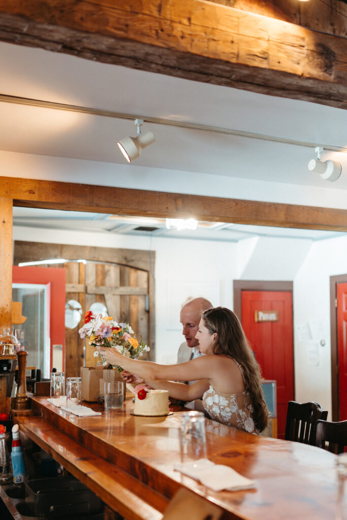 Elopement day cake decorating at White Mountain Cider Co in Bartlett NH 