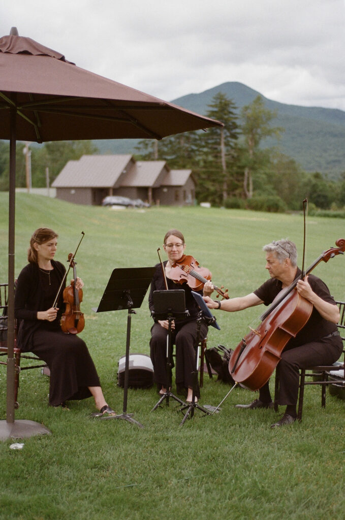 A string trio performing at a ceremony at Mountain Top Resort 