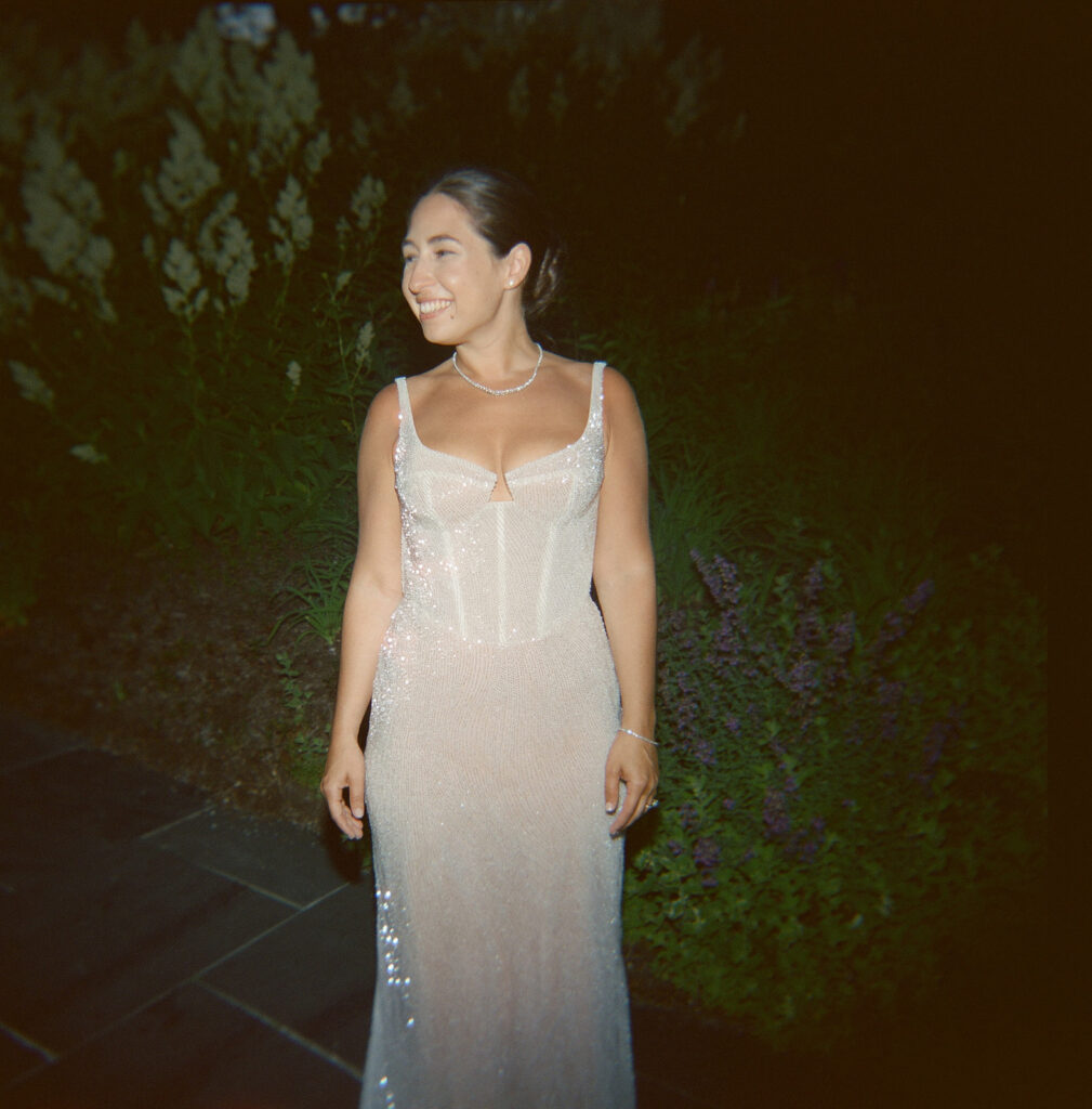 A photo of the bride in her sparkly reception dress with flash. 