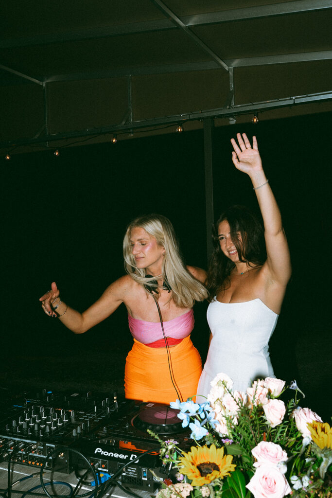 The bride and the DJ at the DJ booth. 