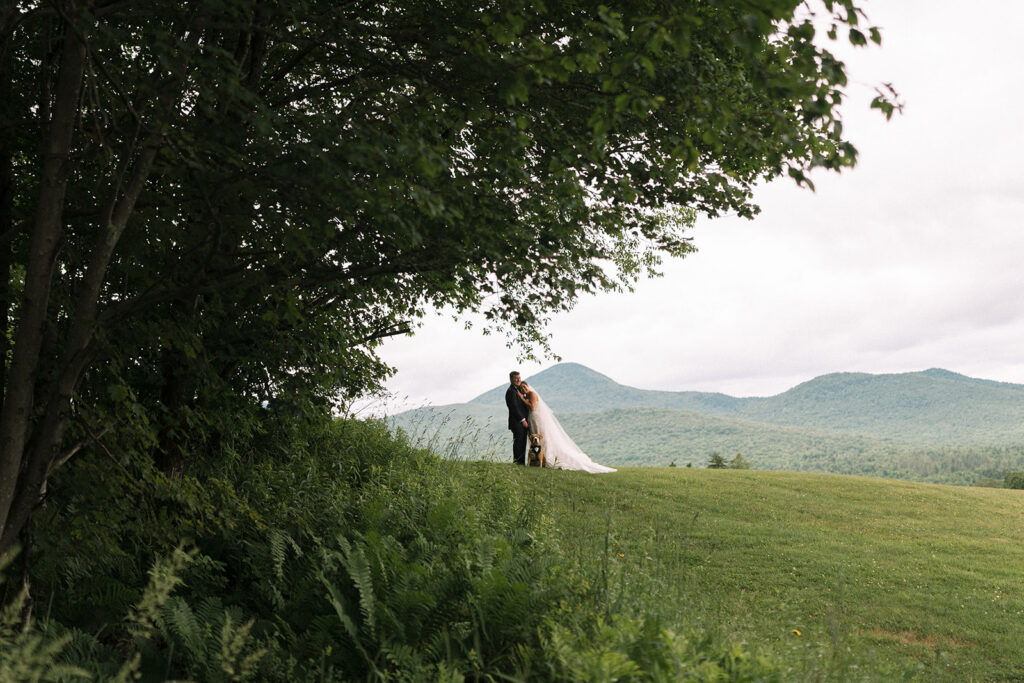 The couple and their dog on a hill at Mountain Top Resort. 