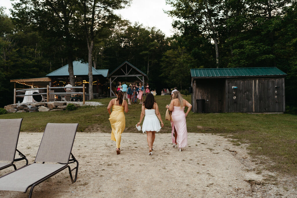 The bride, her mom, and sister walking back up towards the Lakefront Beach Pavilion. 