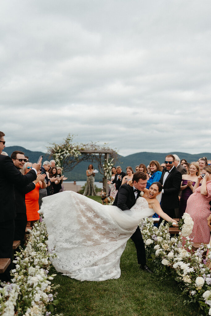 The groom dipping the bride as they walk out of their ceremony at their Mountain Top Resort wedding. 