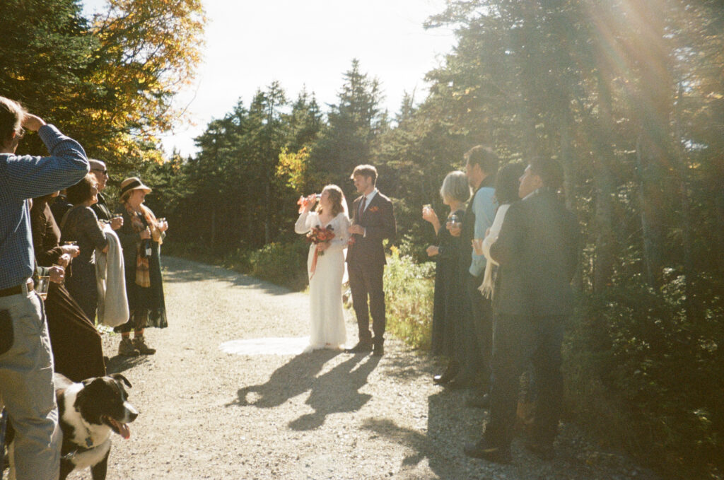The couple drinking champagne surrounded by their family. 